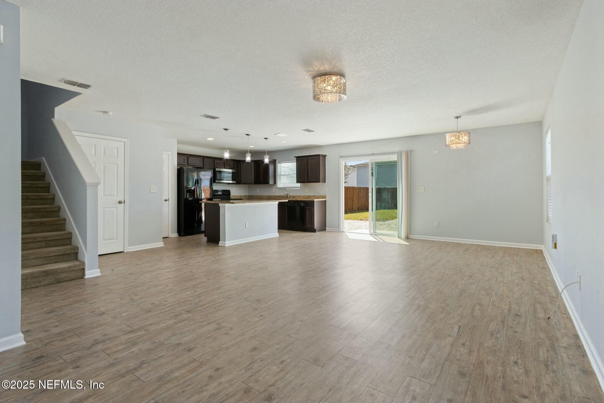 8414 Thor Street Jacksonville, FL 32216 - Photo 12 of 40 a view of a kitchen with a sink and a refrigerator
