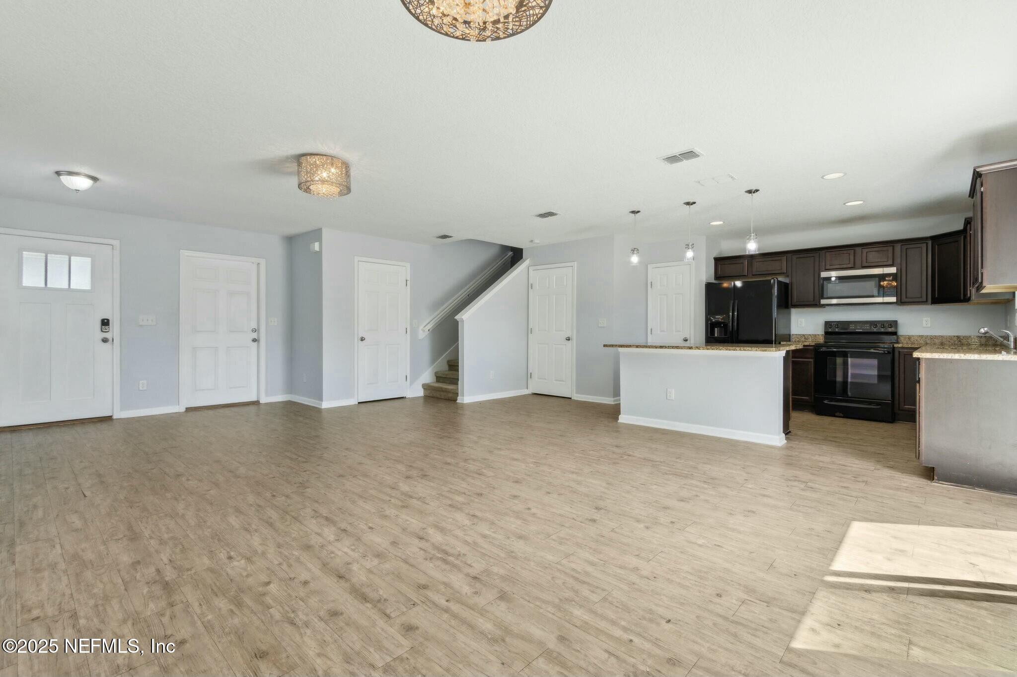 8414 Thor Street Jacksonville, FL 32216 - Photo 14 of 40 a view of a kitchen with a sink and a refrigerator