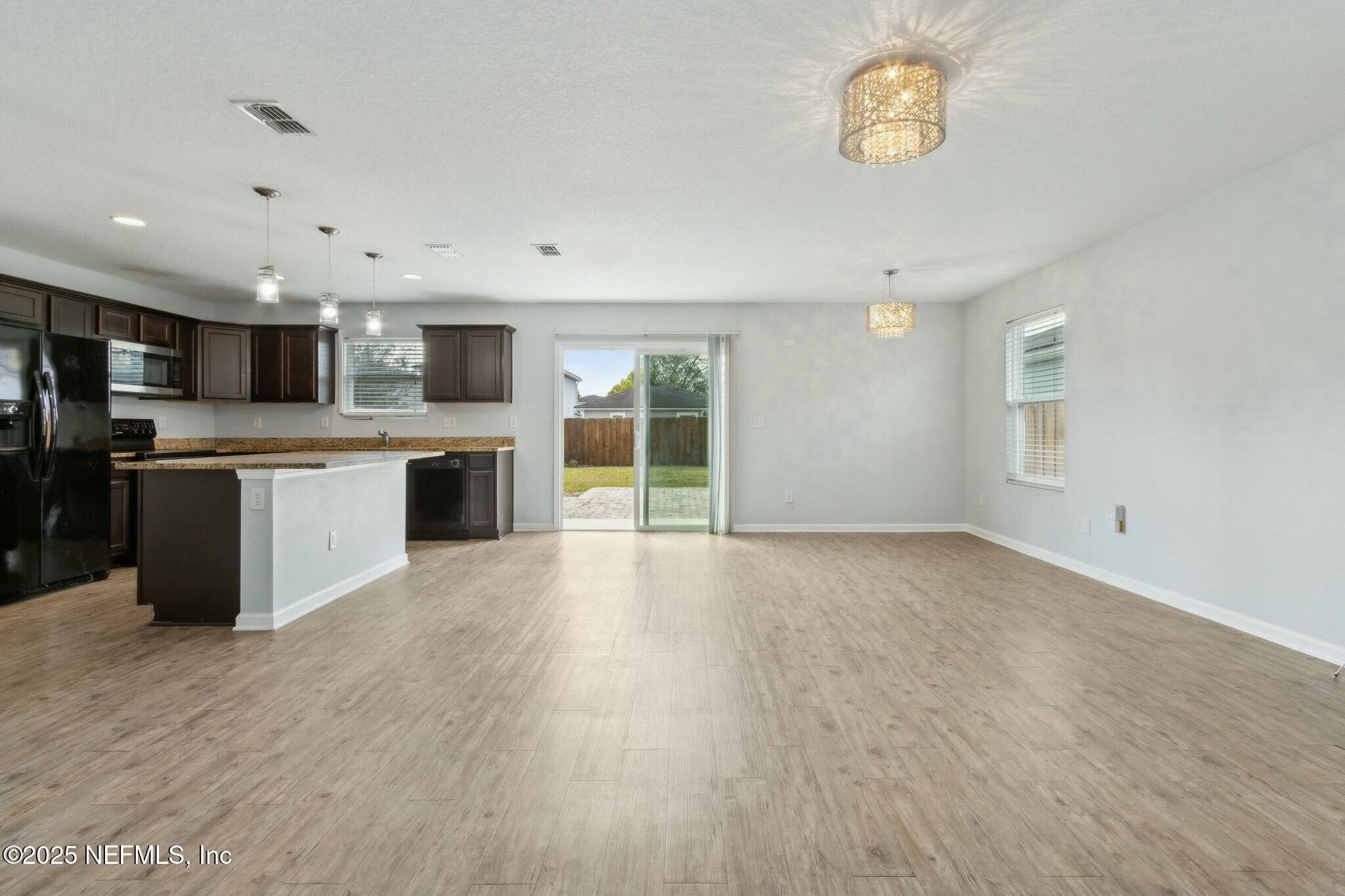 8414 Thor Street Jacksonville, FL 32216 - Photo 17 of 40 a view of kitchen with stainless steel appliances granite countertop a stove top oven a sink dishwasher and a refrigerator with wooden floor