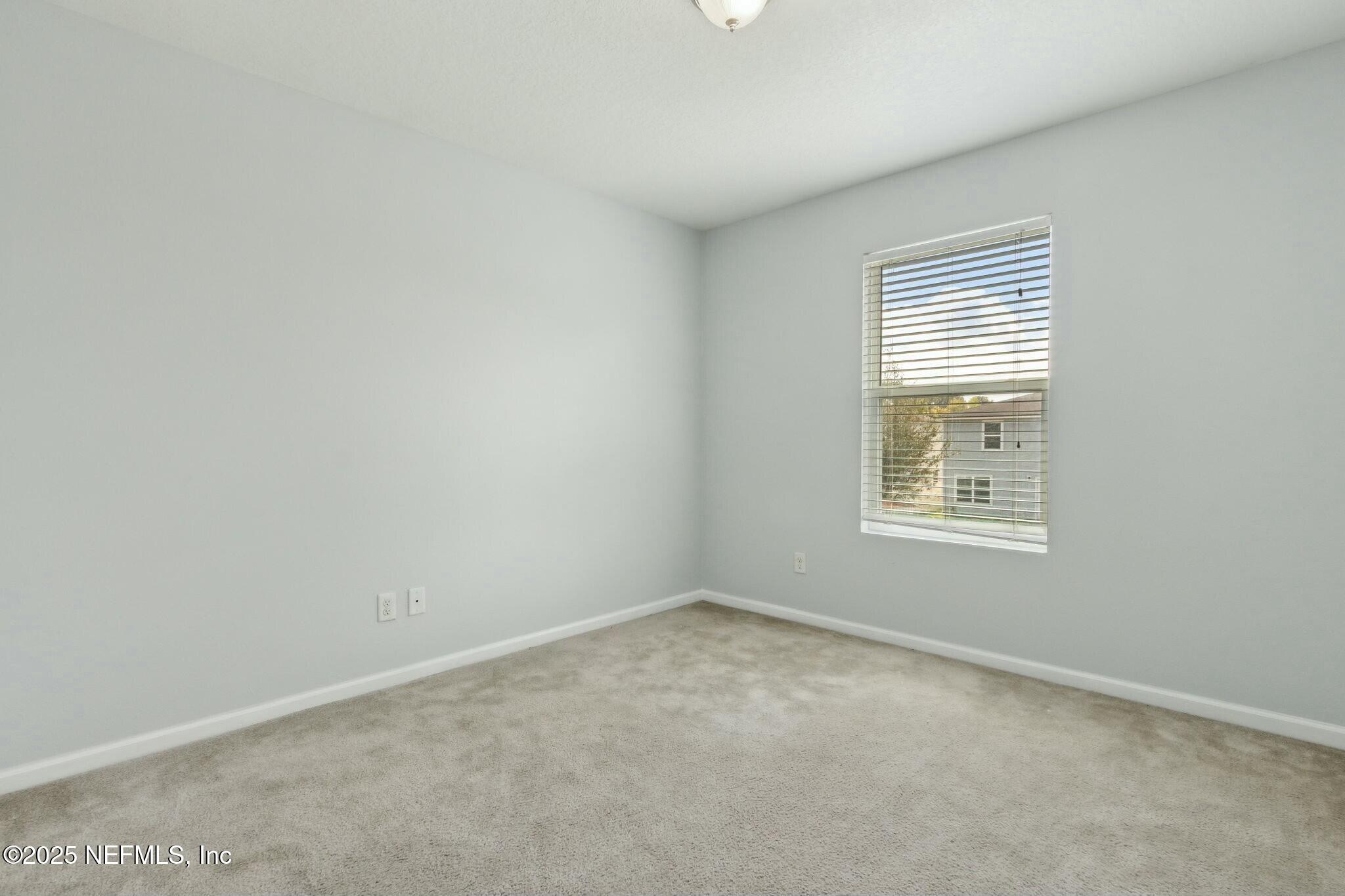8414 Thor Street Jacksonville, FL 32216 - Photo 25 of 40 an empty room with windows