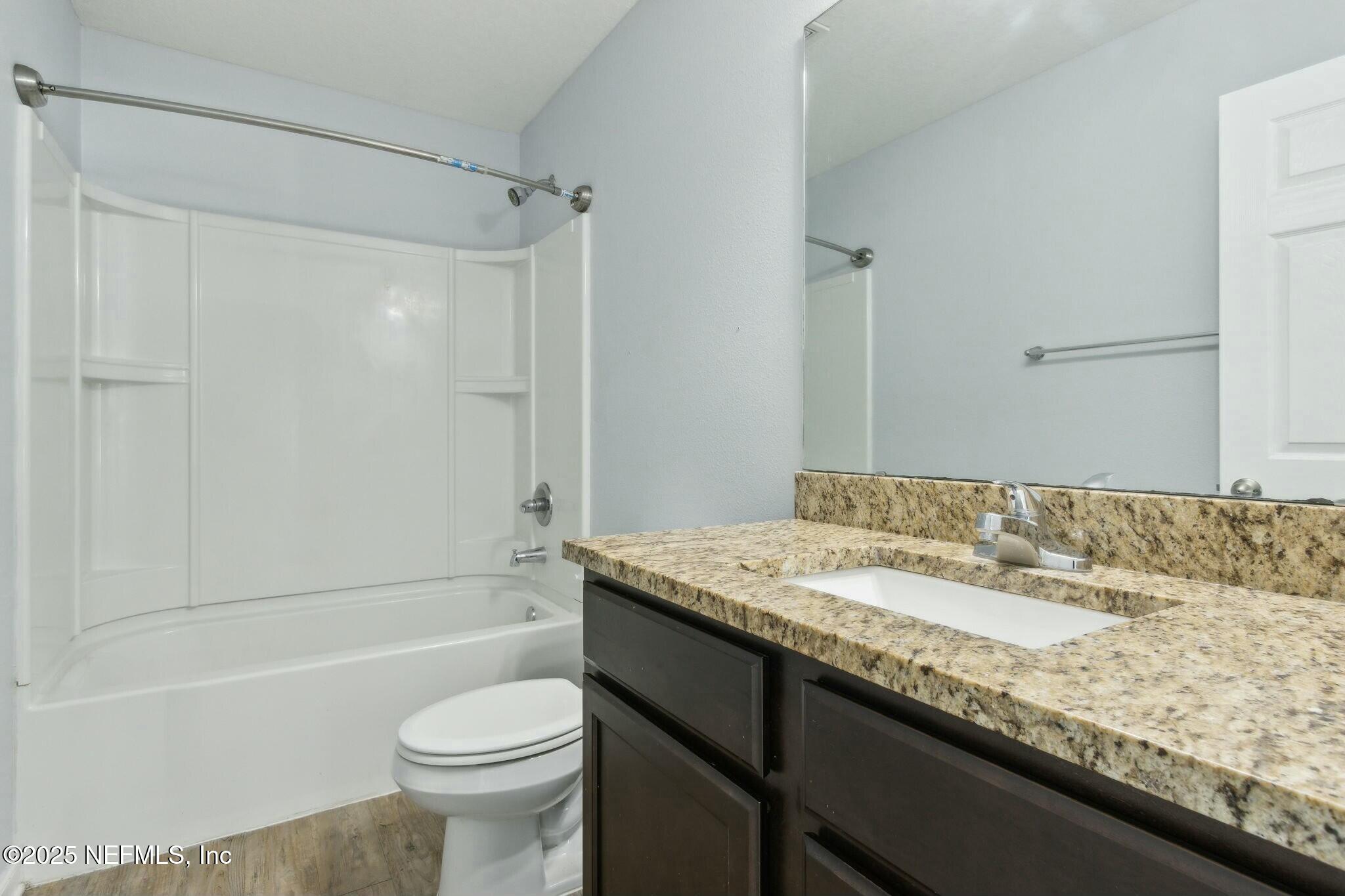 8414 Thor Street Jacksonville, FL 32216 - Photo 27 of 40 a bathroom with a granite countertop sink a toilet and shower