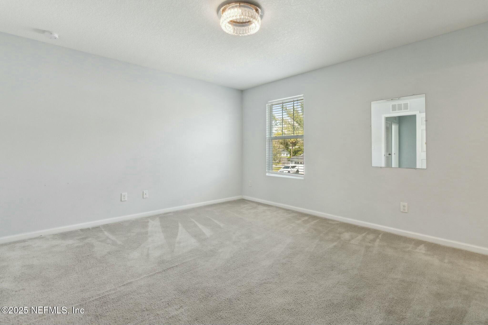 8414 Thor Street Jacksonville, FL 32216 - Photo 30 of 40 an empty room with windows