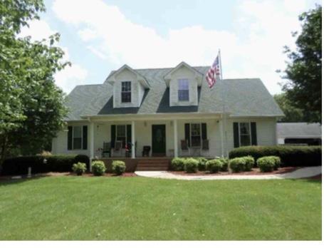 2590 Holloway Road Lebanon, TN 37090 - Photo 1 of 19 a front view of a house with a yard and potted plants