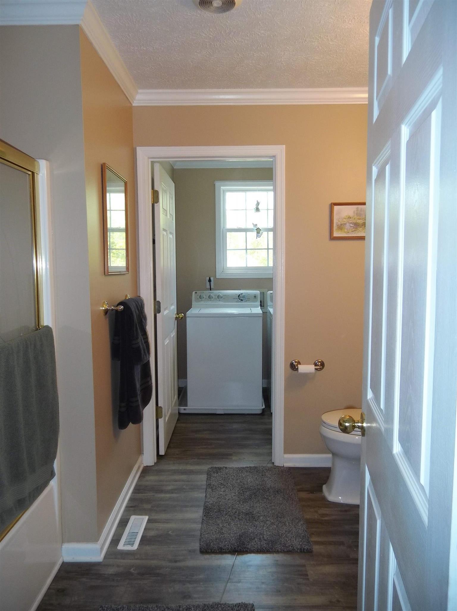 2590 Holloway Road Lebanon, TN 37090 - Photo 12 of 19 a view of a hallway with bathroom and wooden floor