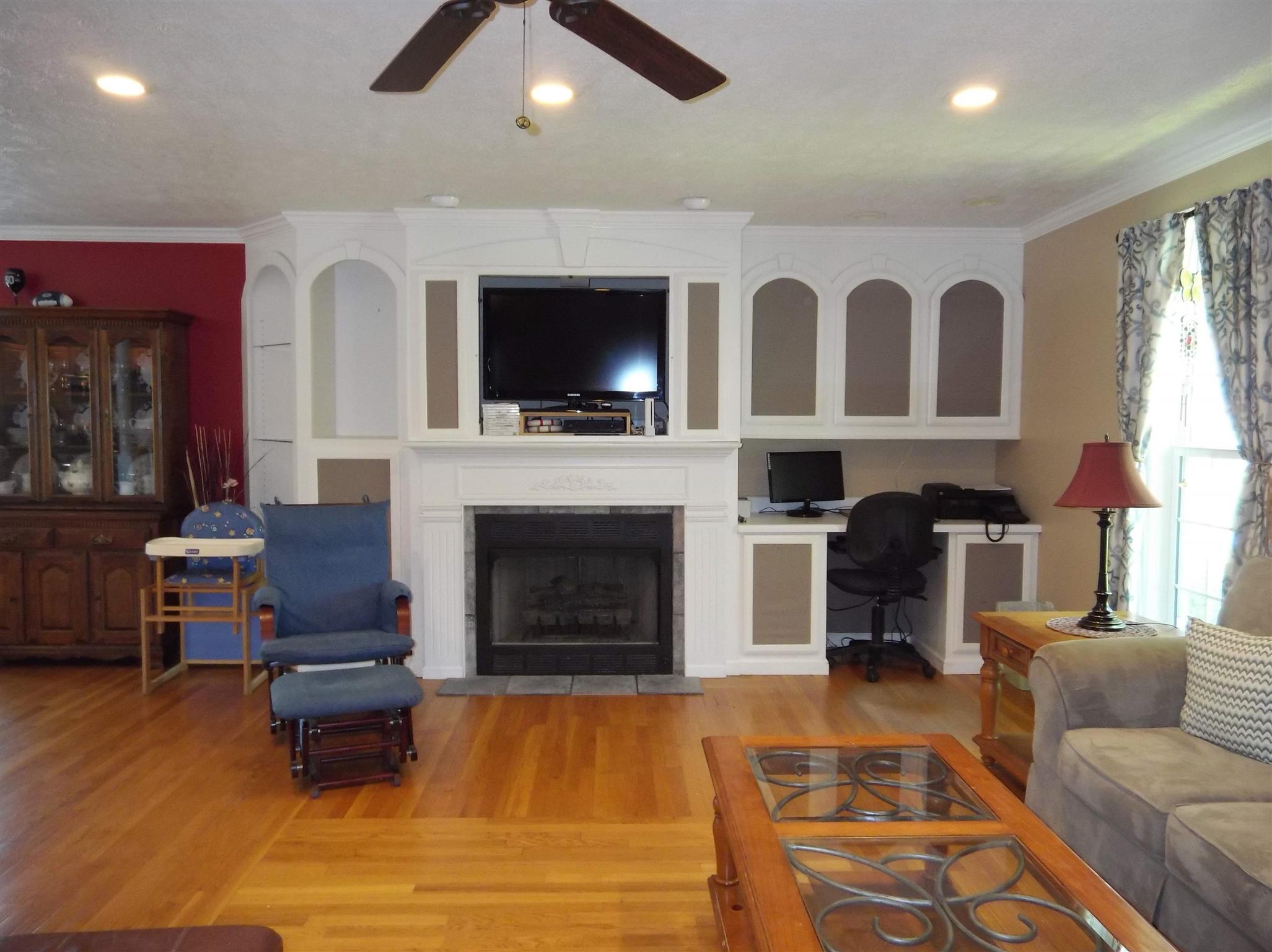 2590 Holloway Road Lebanon, TN 37090 - Photo 8 of 19 a living room with furniture a flat screen tv and a fireplace