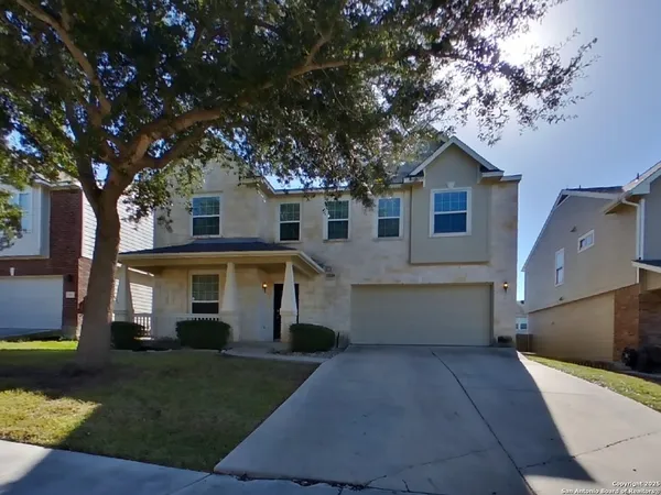 a front view of house with yard and trees