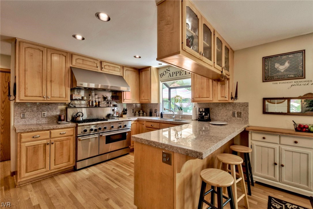 969 Cinnabar Court Incline Village, NV 89451 - Photo 3 of 28 a kitchen with stainless steel appliances granite countertop a stove a sink dishwasher and a refrigerator with wooden floor
