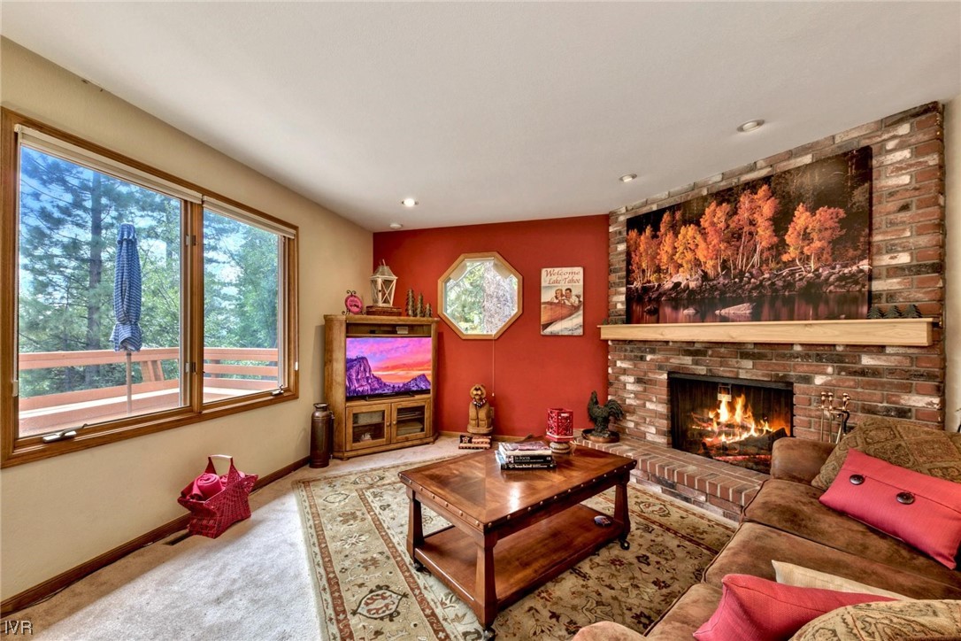 969 Cinnabar Court Incline Village, NV 89451 - Photo 10 of 28 a living room with furniture a fireplace and a floor to ceiling window