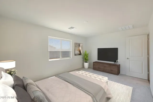 a bedroom with a bed and a flat screen tv