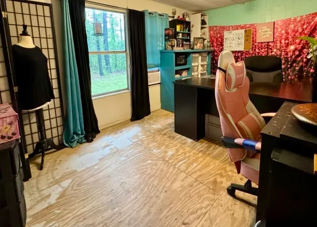 a bedroom with a bed and a flat tv screen on the dresser