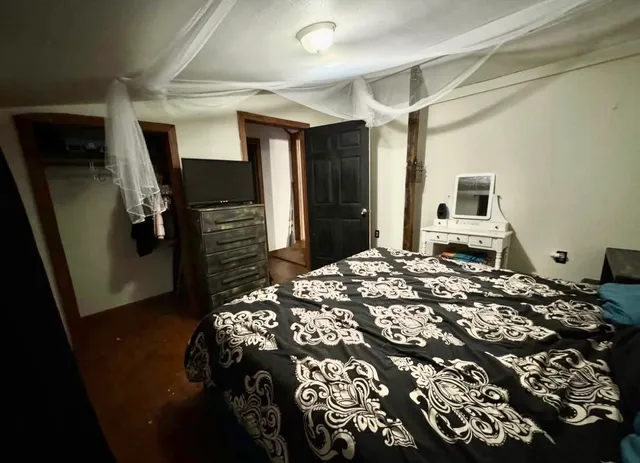 a bedroom with a bed and a mirror