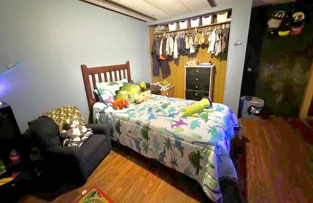 a bedroom with two beds and a window