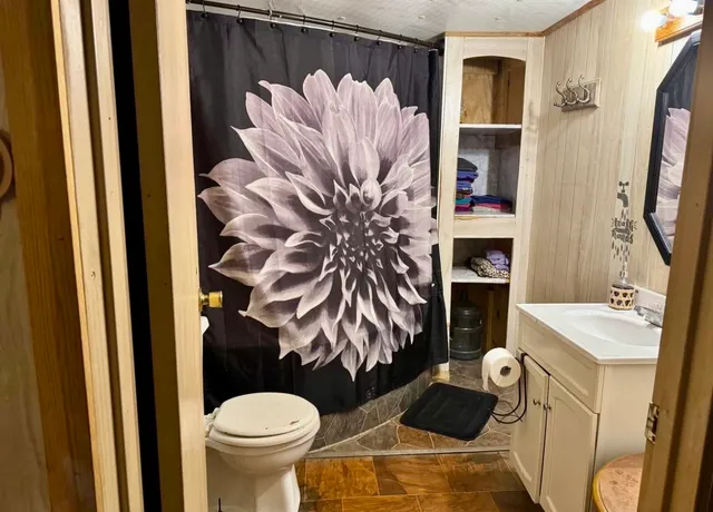 a bathroom with a sink toilet and shower