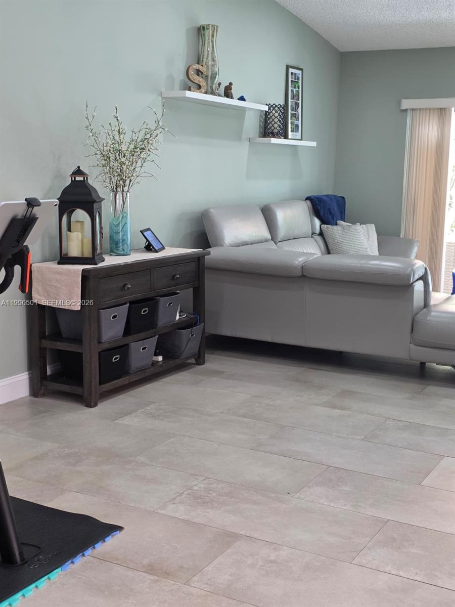 893 Southwest 120th Way Davie, FL 33325 - Photo 12 of 22 a living room with furniture and a couch
