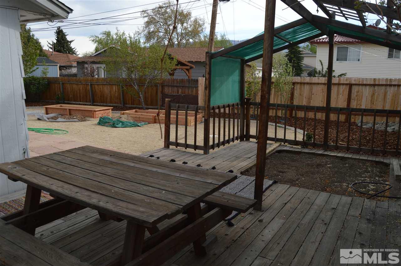 3245 Everett Drive Reno, NV 89503 - Photo 11 of 19 a view of a roof deck with wooden floor and iron fence