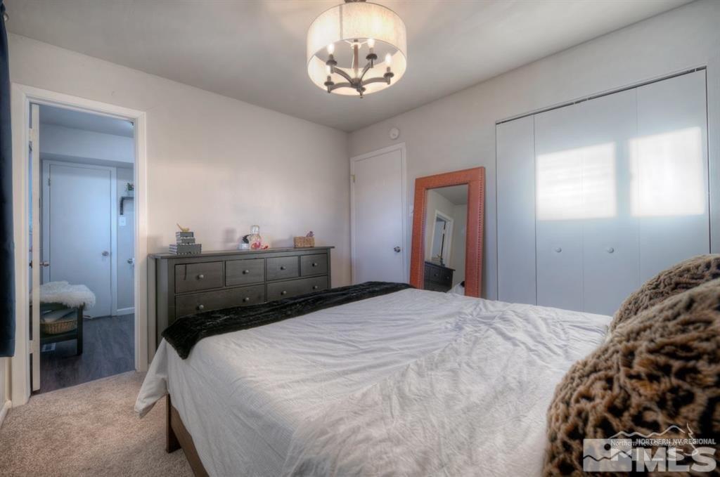 3245 Everett Drive Reno, NV 89503 - Photo 14 of 19 a bedroom with a bed and a chandelier
