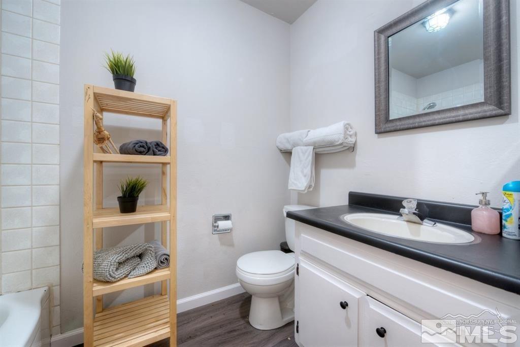 3245 Everett Drive Reno, NV 89503 - Photo 7 of 19 a bathroom with a toilet a sink and mirror