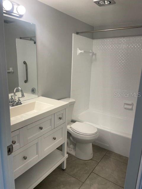 675 Indian Rocks Road North, Unit 103A Belleair Bluffs, FL 33770 - Photo 6 of 10 a bathroom with a double vanity sink mirror and toilet