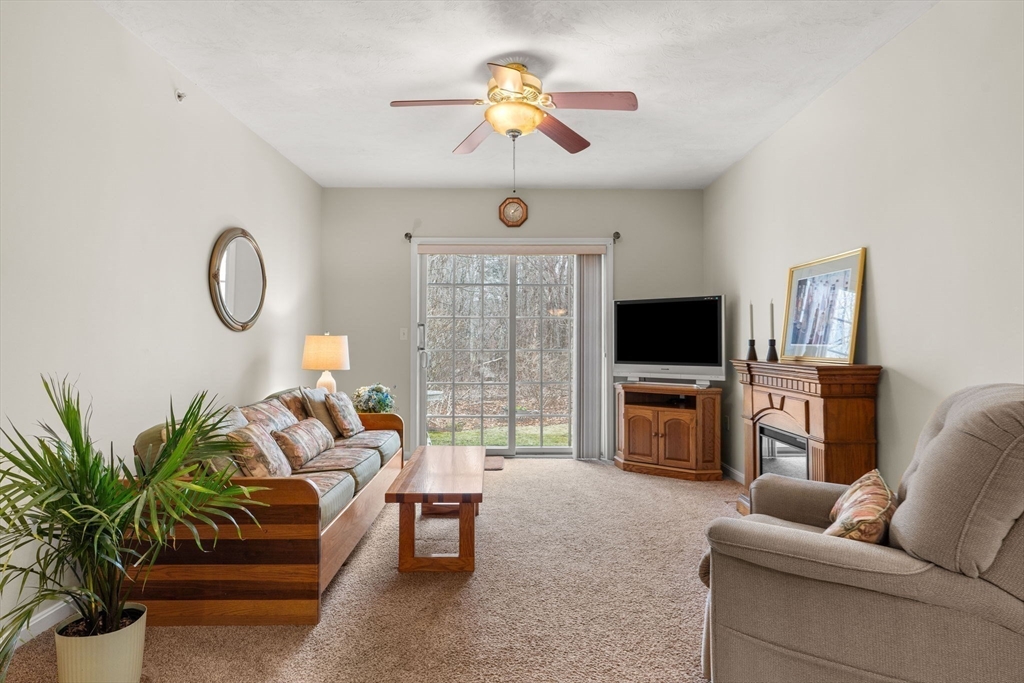 237 Salem Street, Unit 2 Reading, MA 01867 - Photo 12 of 34 a living room with furniture a flat screen tv and a fireplace
