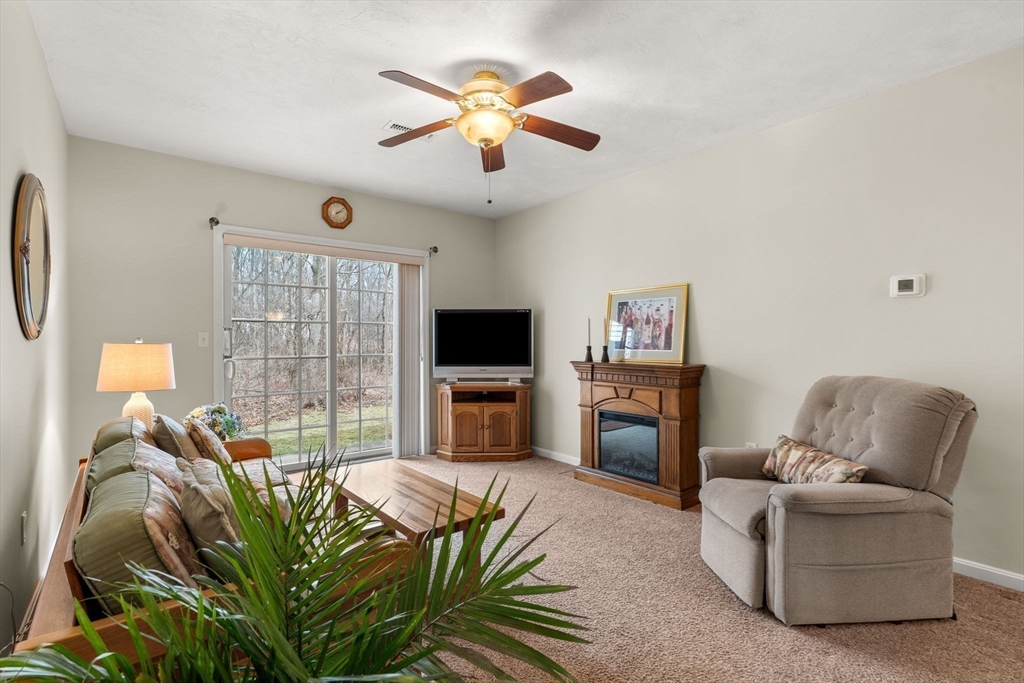 237 Salem Street, Unit 2 Reading, MA 01867 - Photo 13 of 34 a living room with furniture a flat screen tv and a fireplace