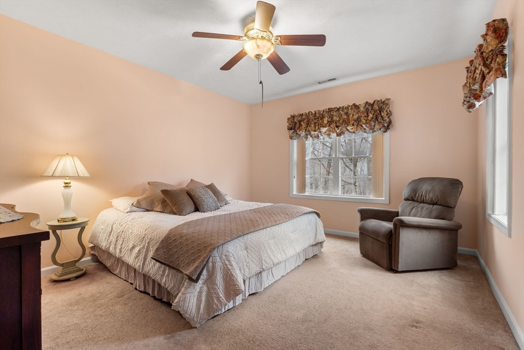 237 Salem Street, Unit 2 Reading, MA 01867 - Photo 16 of 34 a bedroom with bed and a chandelier