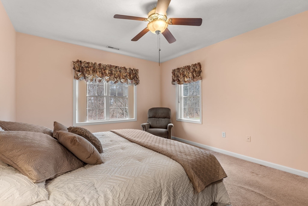 237 Salem Street, Unit 2 Reading, MA 01867 - Photo 17 of 34 a bedroom with a bed and a chandelier