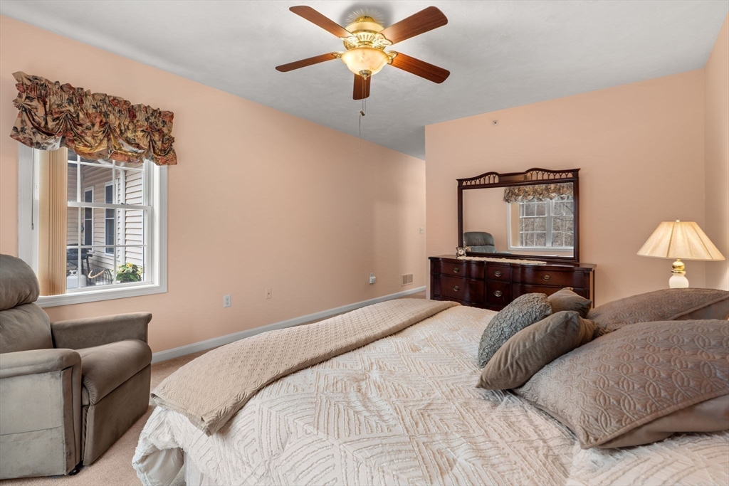 237 Salem Street, Unit 2 Reading, MA 01867 - Photo 18 of 34 a bedroom with a bed and a couch