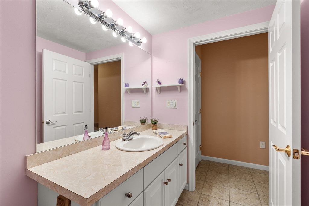 237 Salem Street, Unit 2 Reading, MA 01867 - Photo 22 of 34 a bathroom with a sink a mirror and a shower