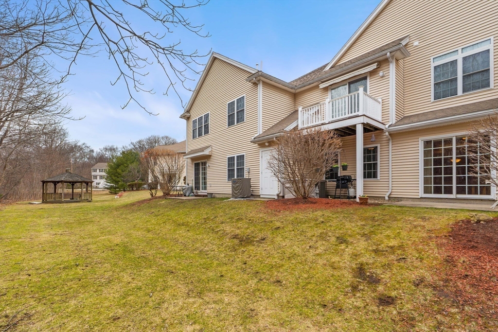 237 Salem Street, Unit 2 Reading, MA 01867 - Photo 29 of 34 a front view of a house with a yard and garage