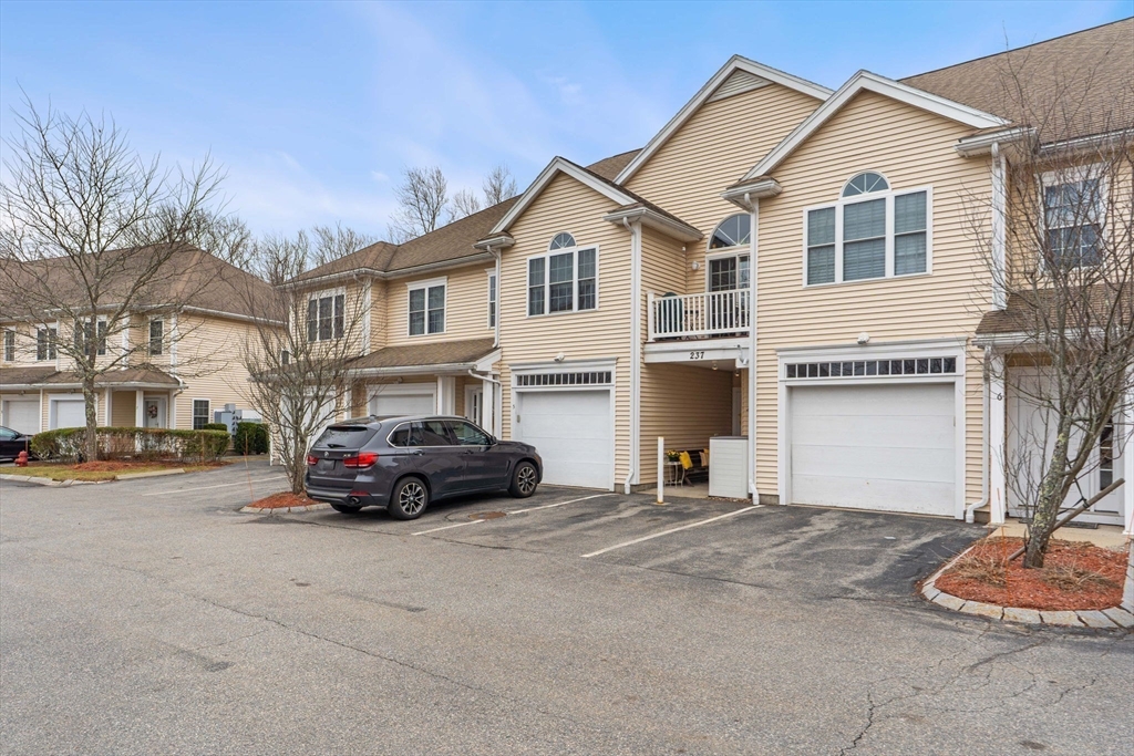 237 Salem Street, Unit 2 Reading, MA 01867 - Photo 32 of 34 a car parked in front of white house