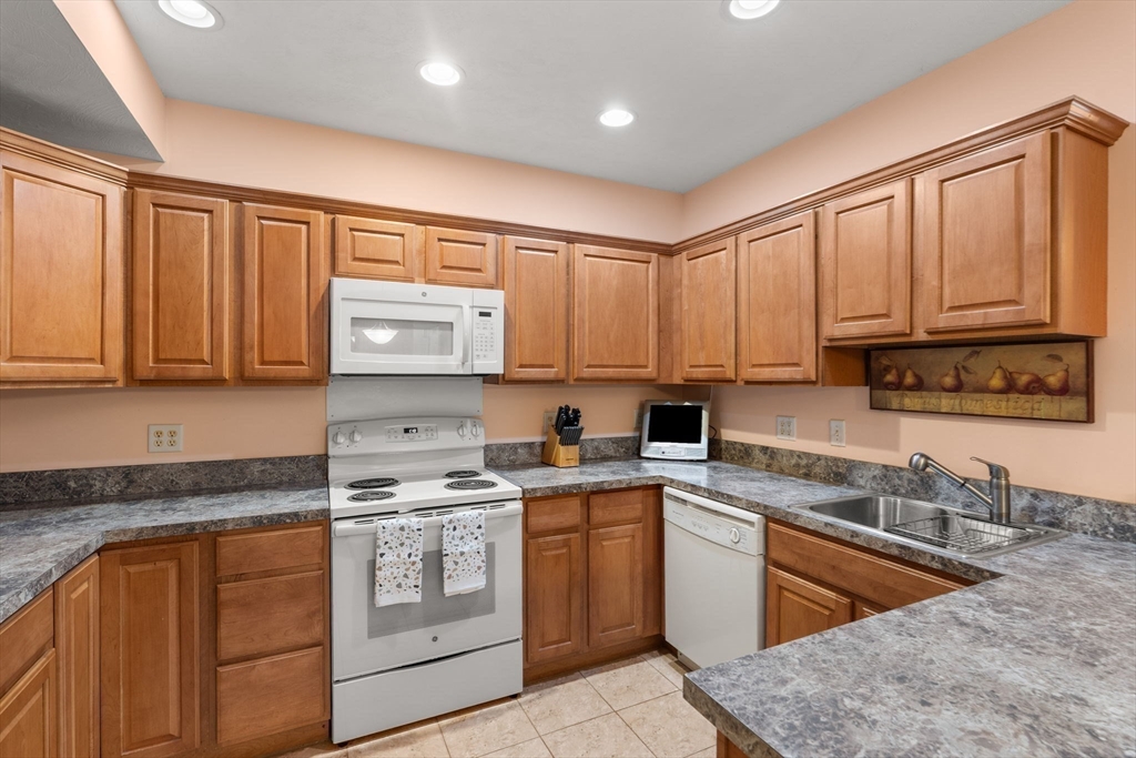 237 Salem Street, Unit 2 Reading, MA 01867 - Photo 7 of 34 a kitchen with stainless steel appliances granite countertop a stove a sink dishwasher and a refrigerator