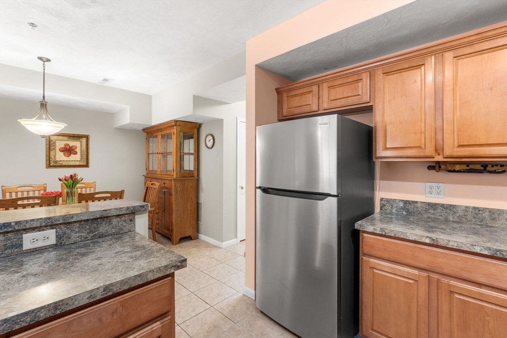 237 Salem Street, Unit 2 Reading, MA 01867 - Photo 8 of 34 a kitchen with stainless steel appliances granite countertop a refrigerator and a sink