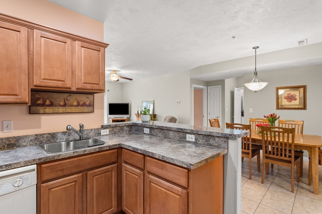 237 Salem Street, Unit 2 Reading, MA 01867 - Photo 9 of 34 a kitchen with granite countertop a sink and cabinets