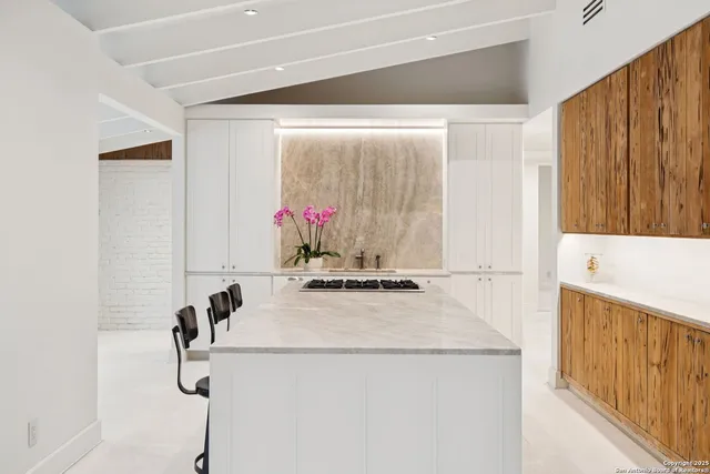 a kitchen with a sink a stove and a refrigerator