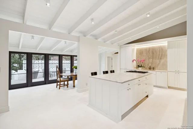 a kitchen with stainless steel appliances granite countertop a stove and cabinets