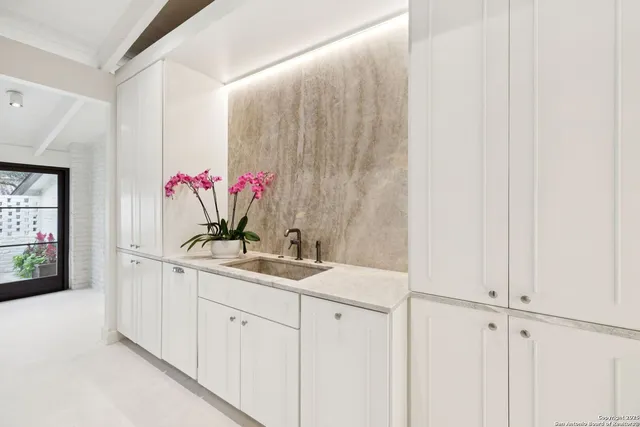 a bathroom with a sink vanity and mirror