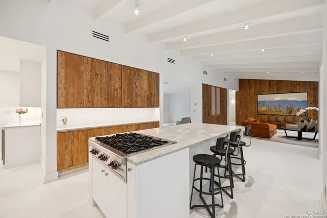 a kitchen that has a table and chairs in it