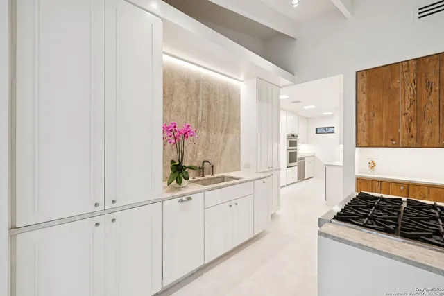 a kitchen with a sink and cabinets