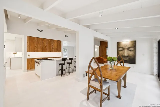 a dining room with furniture and window