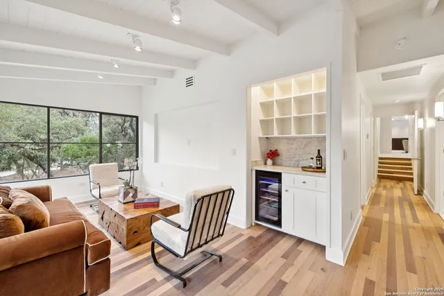 a living room with furniture and a floor to ceiling window