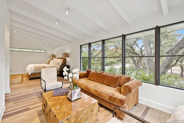 a living room with furniture and a large window