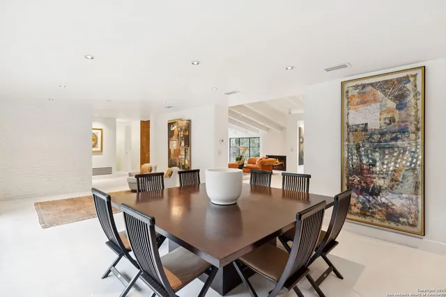 a dining room with furniture and wooden floor