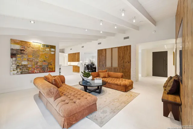 a living room with furniture and large windows