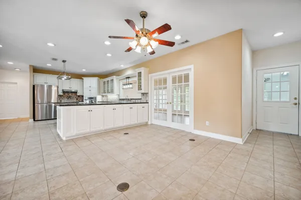 a living room with stainless steel appliances kitchen island granite countertop furniture and a view of kitchen