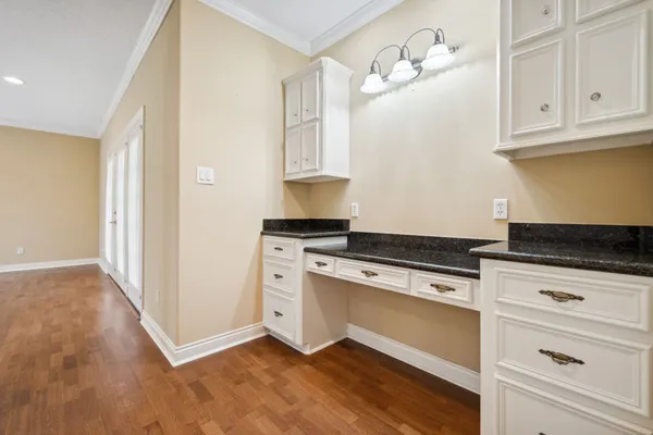 a kitchen with white cabinets and appliances