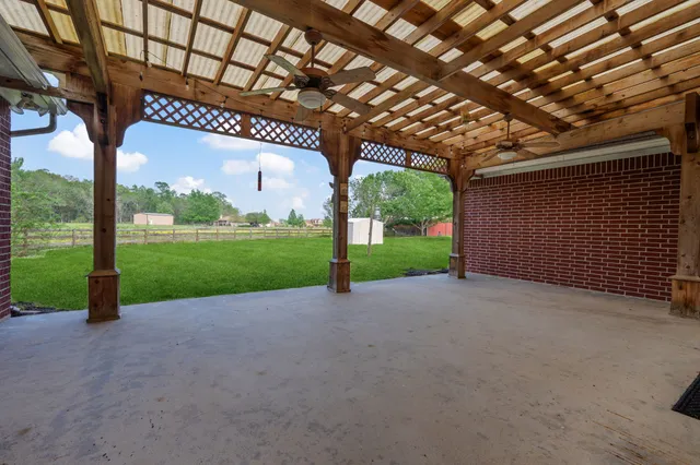 a view of a house with backyard porch and sitting area