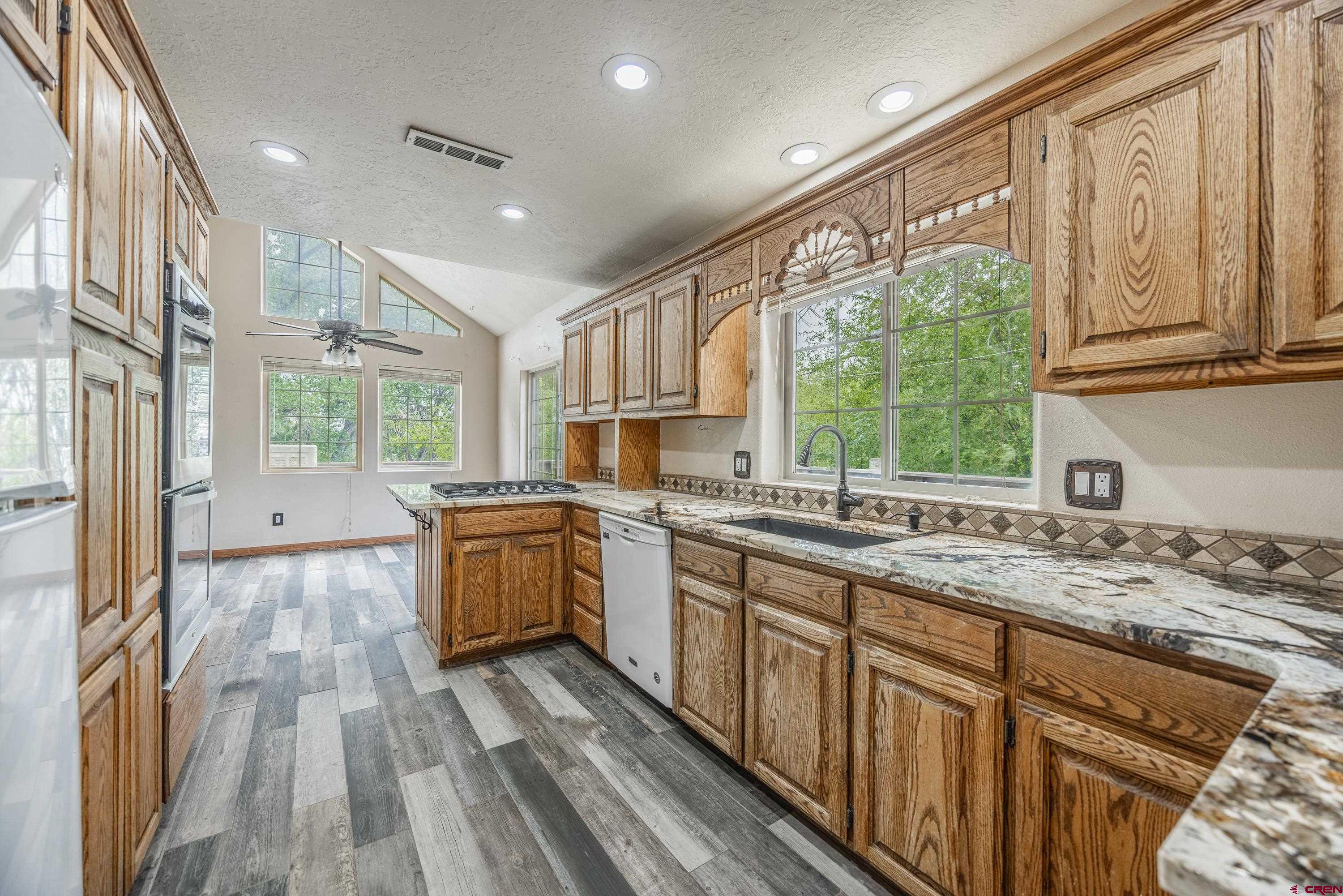 17377 Breeze Road Delta, CO 81416 - Photo 2 of 45 a kitchen with stainless steel appliances granite countertop a sink stove and cabinets