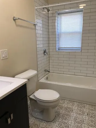 a bathroom with a toilet a sink and bathtub