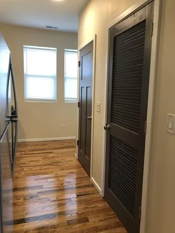 a view of a bathroom with wooden floor and a window