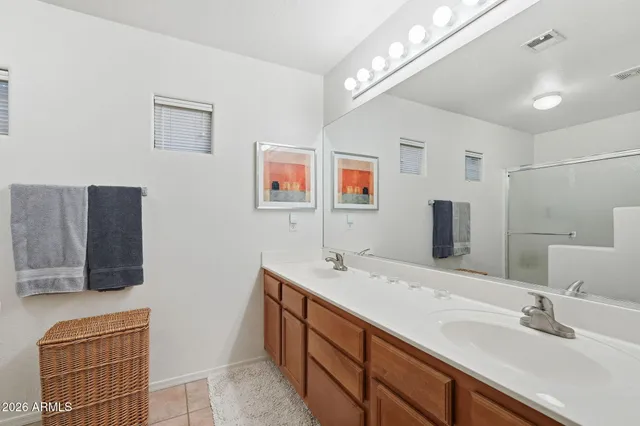 a bathroom with a double vanity sink and a mirror